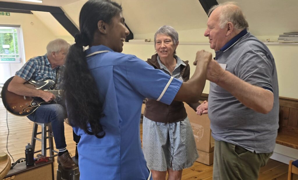 Residents and carers dancing