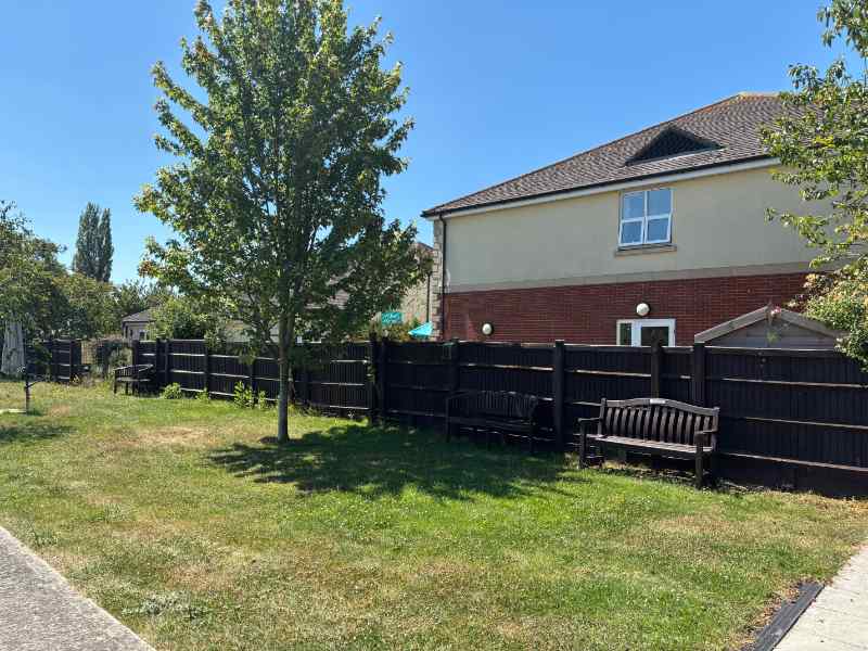 garden area with bench at immacolata house care home in seaton