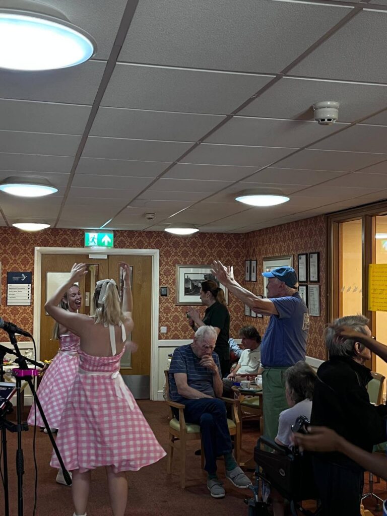Residents singing along during entertainment at the Dementia Café