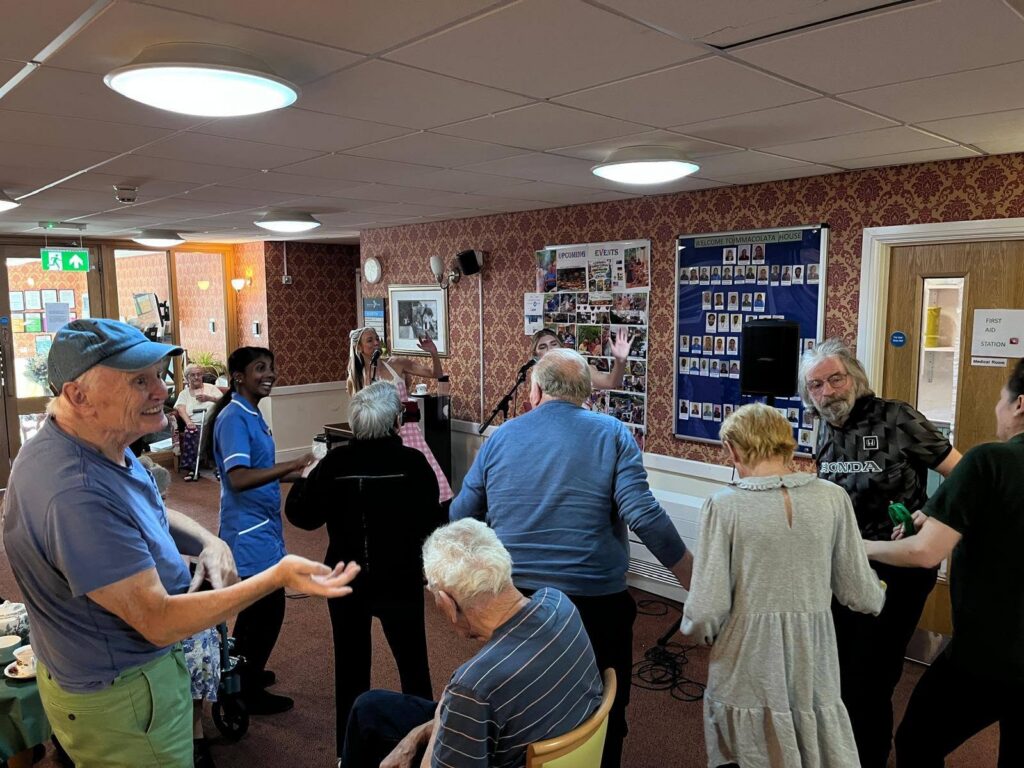 Residents and visitors enjoying music together at Immacolata's Dementia Café